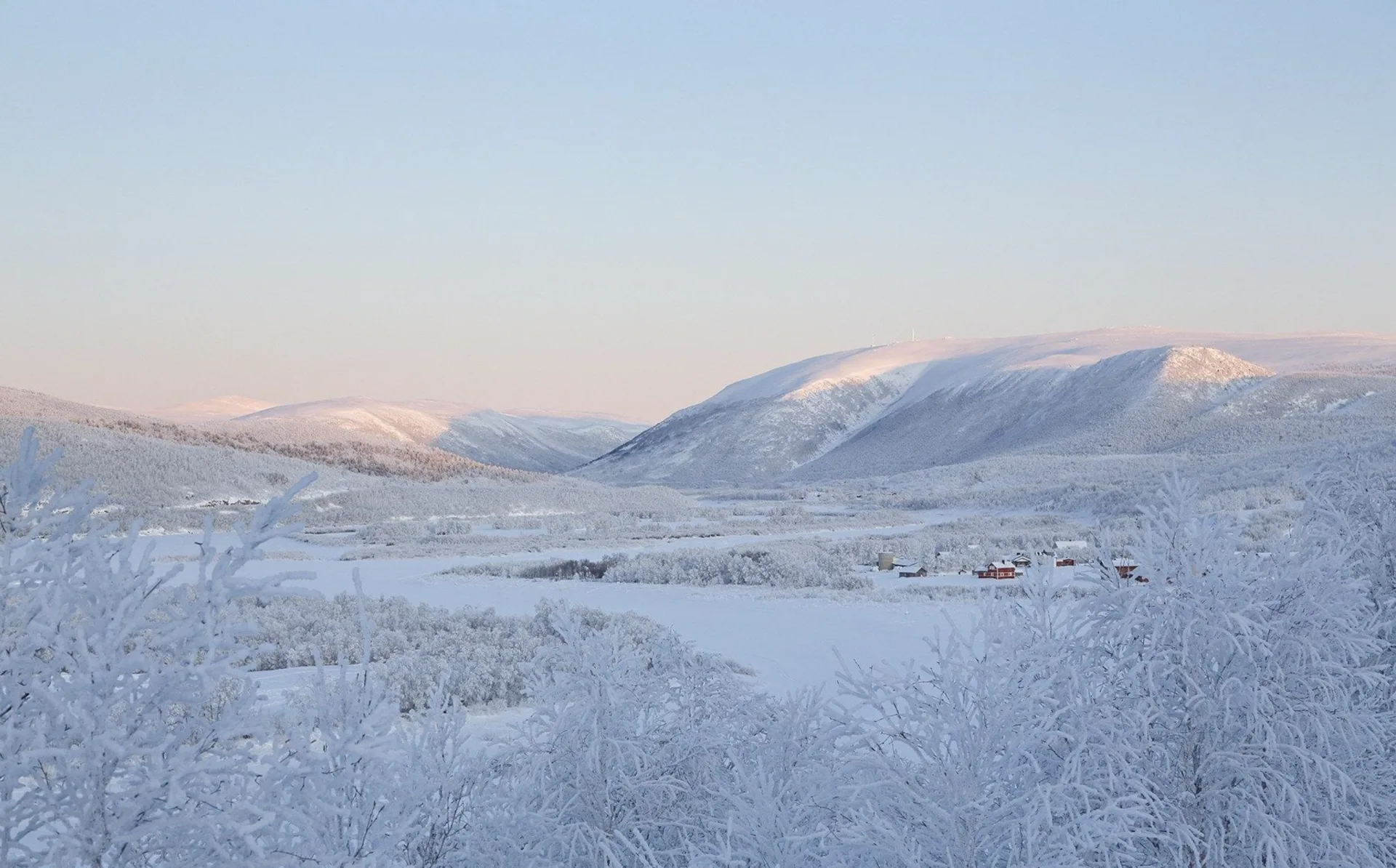 A snow-bound Lapland valley at blue hour