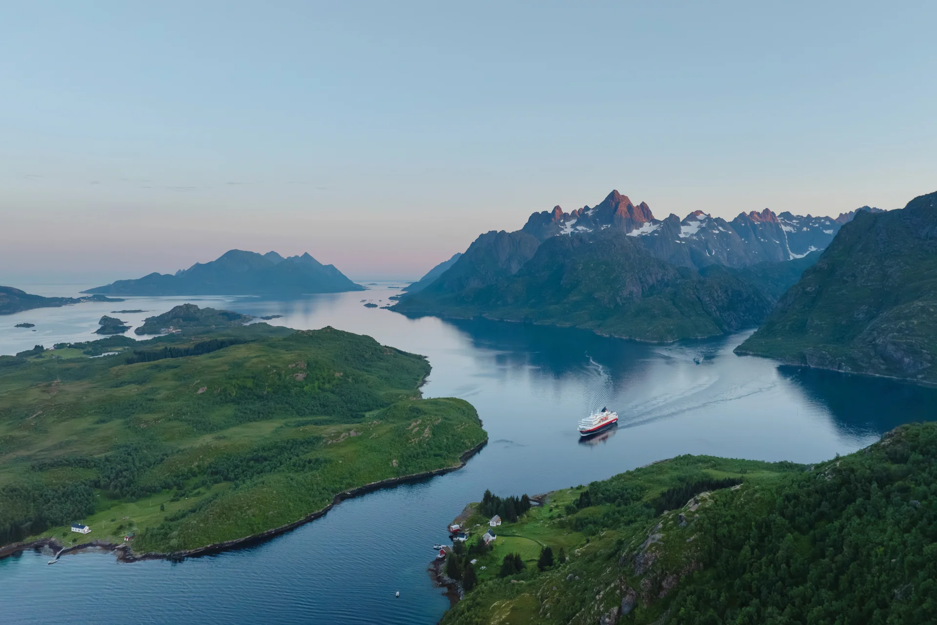 A coastal vessel threading still arctic water