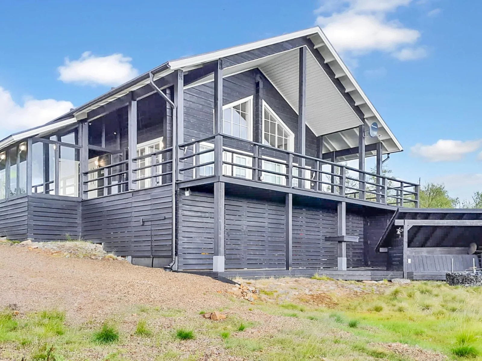 Kontiokota, a grey timber chalet with a raised balcony