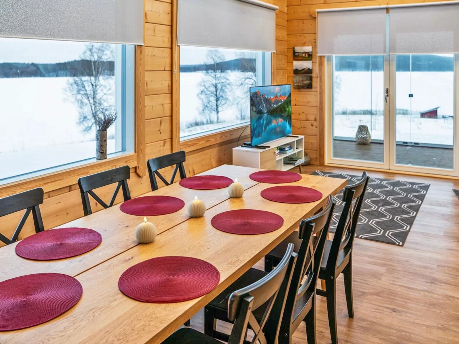 The dining table at Villa Lehtoniemi, with the frozen lake beyond the windows