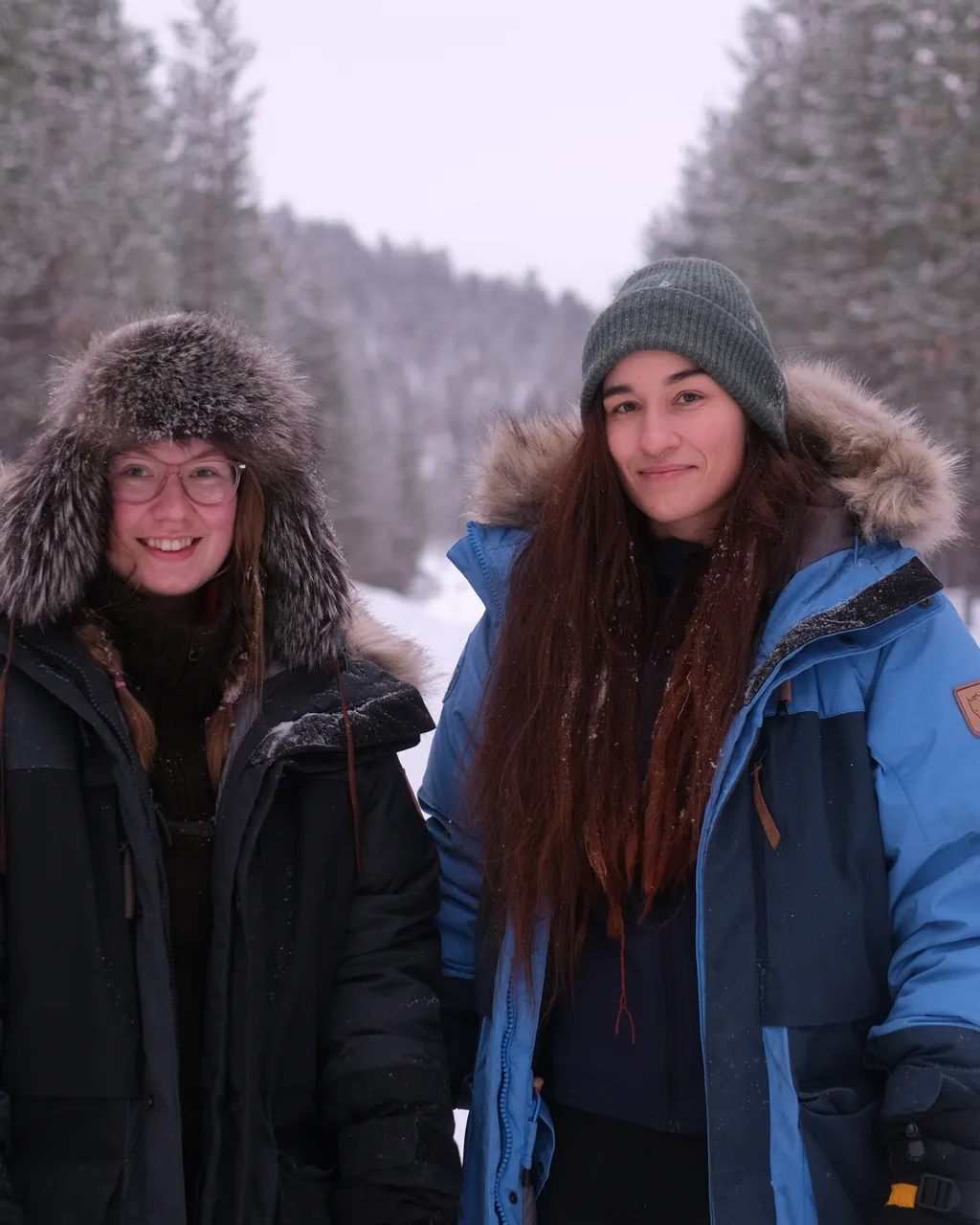 Two of the Private Nordic concierge team, on a forest road by Inari in winter